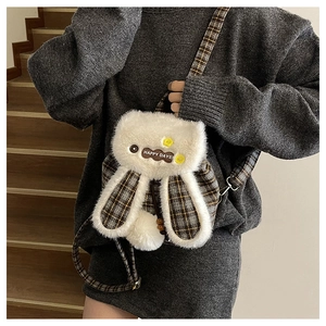 Detail of plush rabbit-shaped crossbody bag featuring checkered fabric and happy days patch