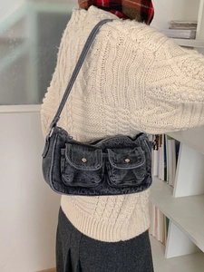 Vintage washed black denim baguette shoulder bag with cargo pockets worn by model
