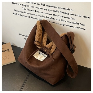 Close-up of brown suede bag with white fleece lining and drawstring detail