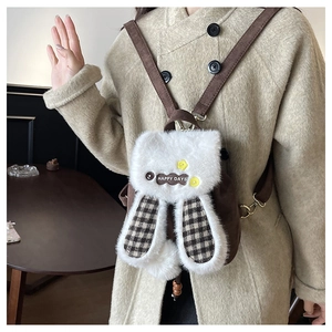 Detail of cute plush bunny backpack with long ears and HAPPY DAYS embroidery decoration
