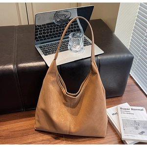 Detailed close-up of brown frosted tote bag showing matte texture and long shoulder strap