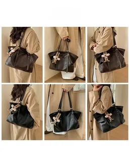 Detailed view of large retro PU leather tote bag with side rivets and a cute puppy charm