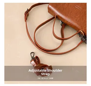 Details des verstellbaren Riemens und Bronze-Hardware an brauner Retro-Handtasche