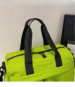 Close-up of neon green fitness bag with smooth adjustable black shoulder strap and zipper
