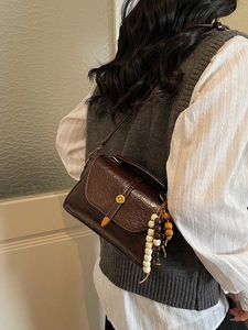 Vintage brown crossbody bag with oil wax texture and decorative wooden beads