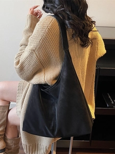 Retro matte black tote bag with large capacity shown in a lifestyle model shot