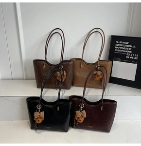 Macro shot of faux leather tote bags in four retro colors with cute bear charms