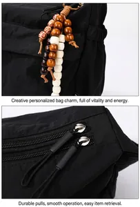 Detail of nylon bag featuring wooden bead charm and smooth dual zipper closure