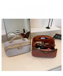 Interior detail of large capacity suede makeup bags with organized compartments and zippers