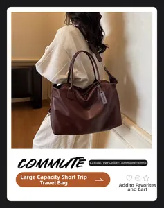 Detail of dark reddish-brown leather travel bag with textured handle and hanging luggage tag
