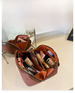 Detailed internal view of large capacity pink suede makeup bag with organized sections
