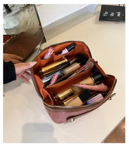 Detail of multi-compartment suede makeup box showing large capacity for cosmetics