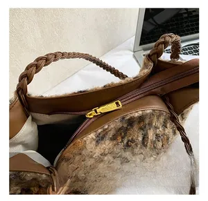 Close-up of leopard print faux fur tote bag with braided handle and gold metal zipper
