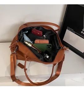 Interior view showing the large storage capacity of the brown tote bag with essentials