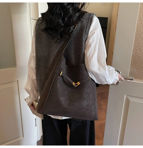 Deep coffee large bucket bag shown on shoulder for a minimalist aesthetic style