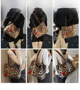 Detail view of leopard print plush tote bag with colorful pom-poms and braided strap