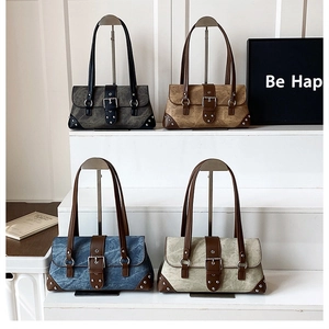 Chic retro underarm bags in grey, brown, denim, and beige with metallic stud details