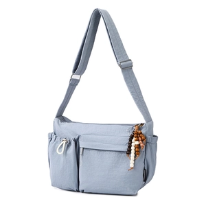 Detail of Morandi blue nylon crossbody bag with ethnic beads and adjustable strap