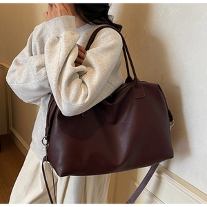 Deep brown large travel tote bag with leather texture and detachable long shoulder strap
