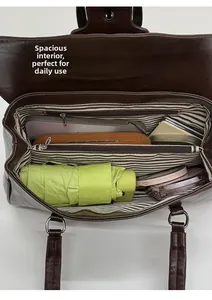 Interior view of brown leather bag showing spacious compartments and striped lining