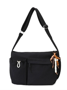 Black versatile crossbody tote bag with adjustable strap and decorative beaded tassel