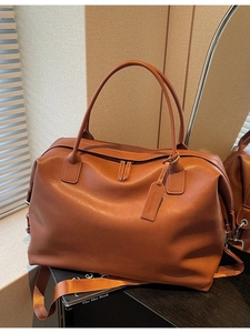 Caramel leather large travel tote bag with dual handles and adjustable shoulder strap