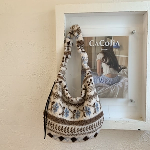 Detail view of a soft plush tote bag with vintage blue and brown floral patterns
