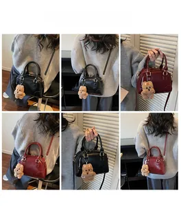 Detailed model views of a retro bowling bag with a plush bear charm and pebbled texture