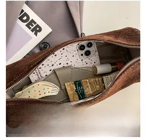 Detail show of leopard print cylinder bag interior with grey lining and metal zipper