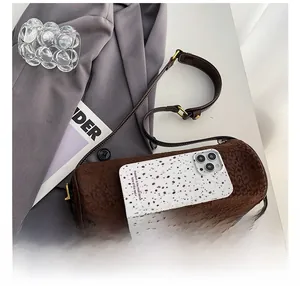 Deep coffee cylinder bag with leopard texture and smartphone for size comparison