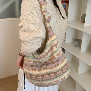 Detailed view of striped plush tote bag with soft faux fur texture and wide shoulder strap