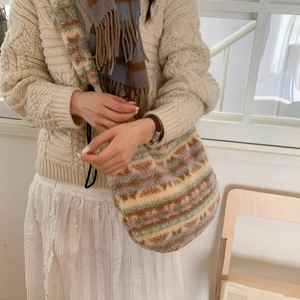 Detail of soft plush tote bag with colorful geometric patchwork and wide shoulder strap