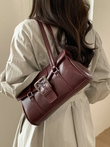Retro burgundy rectangular underarm bag in glossy leather with silver buckle strap detail