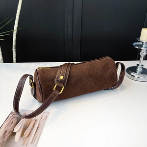 Detail of leopard print cylinder bag featuring contrast stitching and gold hardware