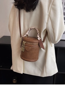 Retro dark brown cylinder crossbody bag with floral scarf handle and gold lock detail