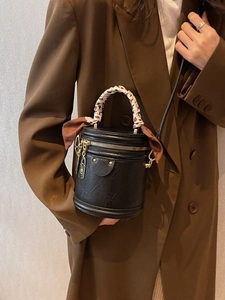 Vintage black cylindrical leather bucket bag with leopard print scarf and gold hardware