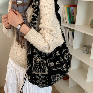 Detail of large plush tote bag with black and white patterns for winter casual use