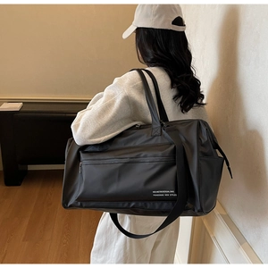 Vue détaillée du grand sac de voyage étanche avec bandoulière et garnitures métalliques