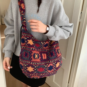 Detailed close-up of large plush hobo bag with colorful ethnic geometric patterns