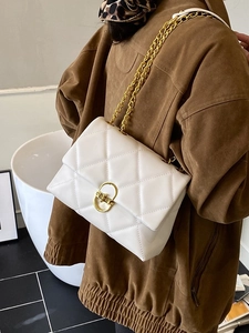 White quilted crossbody bag with gold chain strap and elegant diamond lattice pattern
