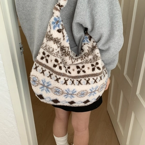 Detail of soft fuzzy hobo bag with vintage snowflake patterns and large capacity