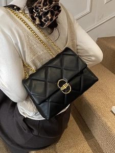 Chic black quilted hobo bag with gold chain strap and oval lock for daily commuting