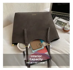 Detail view of large brown tote bag showing internal storage for tablet and cosmetics