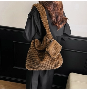 Detail of brown plush faux fur tote bag with matching pouch on model shoulder