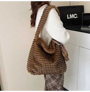 Detailed texture of brown waffle pattern plush tote bag worn over the shoulder