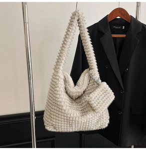 Detail of plush off-white checkerboard faux fur tote bag with a matching small zipper pouch