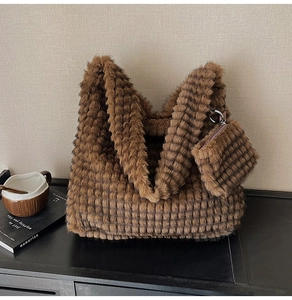 Detail of brown faux fur tote with checkered texture and matching small coin purse
