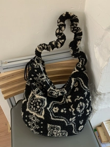 Bohemian fuzzy tote bag with black and white paisley pattern and ruffled shoulder strap