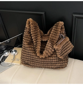 Detail view of brown plush tote bag set including a large bucket bag and matching pouch