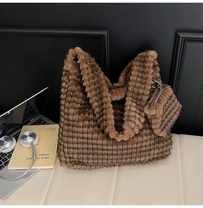 Close-up of brown faux fur tote bag with striped texture and matching small coin purse